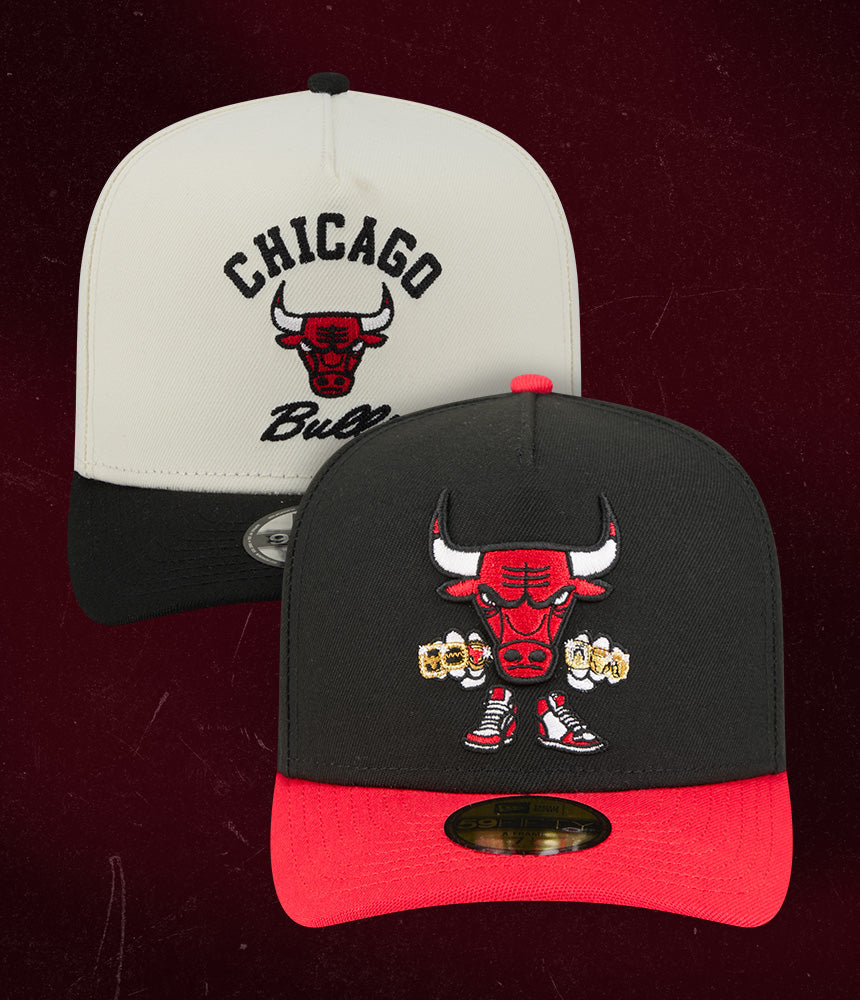 Two Chicago Bulls caps, one white and black, the other black and red, on a dark background.